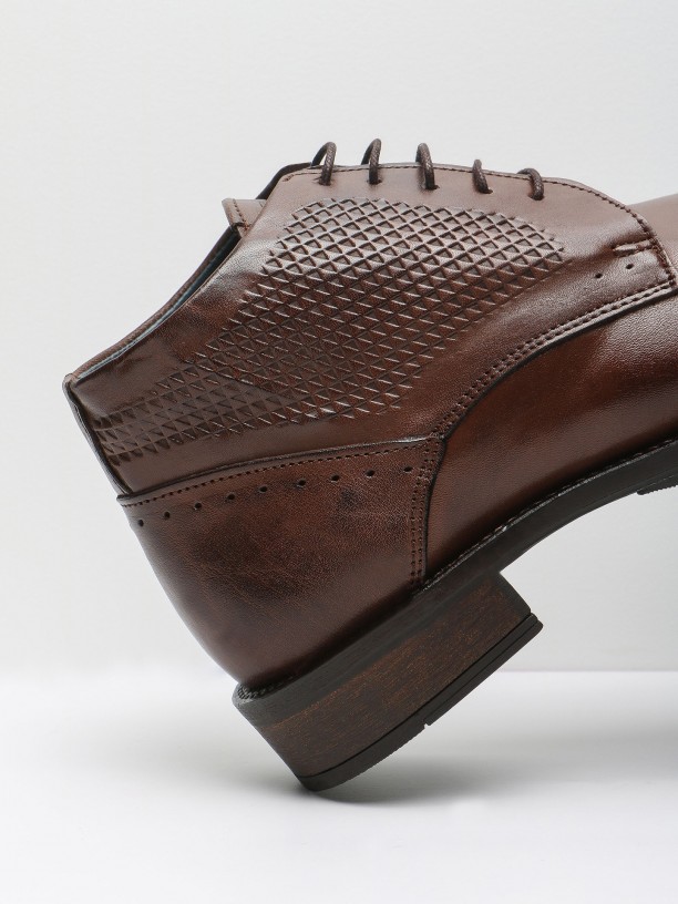 Polished leather boots with embossed pattern